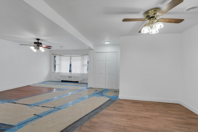 empty room with hardwood / wood-style flooring and ceiling fan