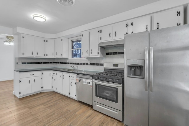 kitchen with white cabinetry, appliances with stainless steel finishes, sink, and backsplash