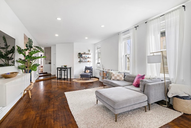 living room featuring baseboards, hardwood / wood-style floors, and recessed lighting