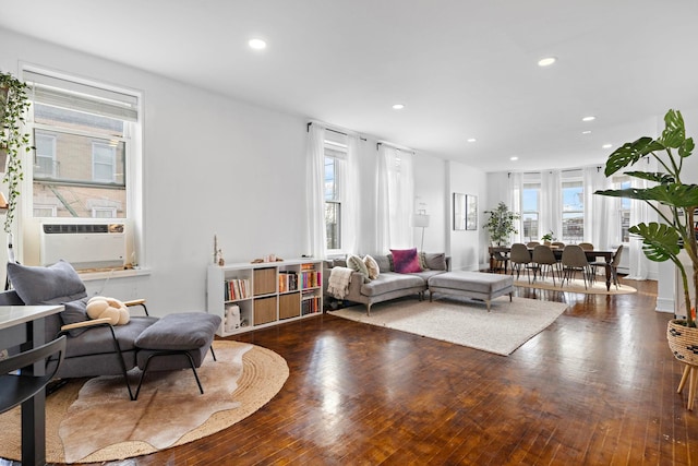 living area with wood-type flooring, cooling unit, and recessed lighting