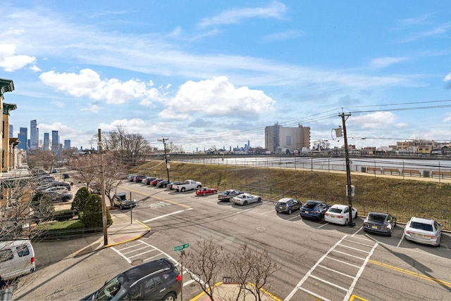 uncovered parking lot featuring a city view