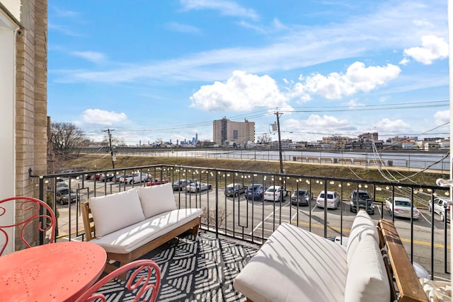 balcony featuring an outdoor living space and a city view