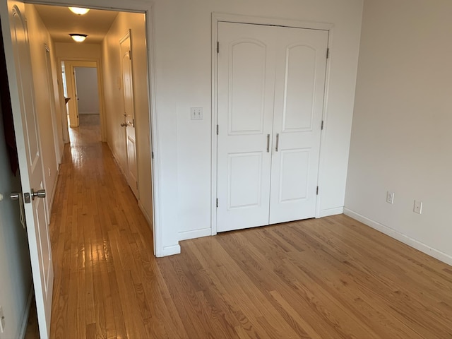 612 Palisade Ave, Jersey City, NJ 07307 - unfurnished bedroom with a closet, light wood finished floors, and baseboards