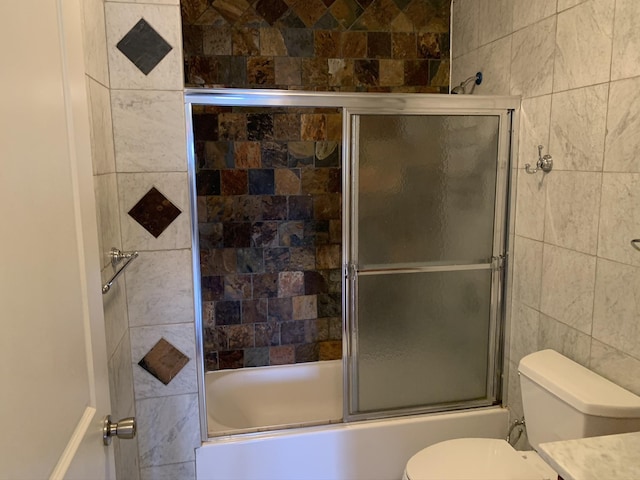 612 Palisade Ave, Jersey City, NJ 07307 - bathroom featuring tile walls, toilet, combined bath / shower with glass door, and vanity