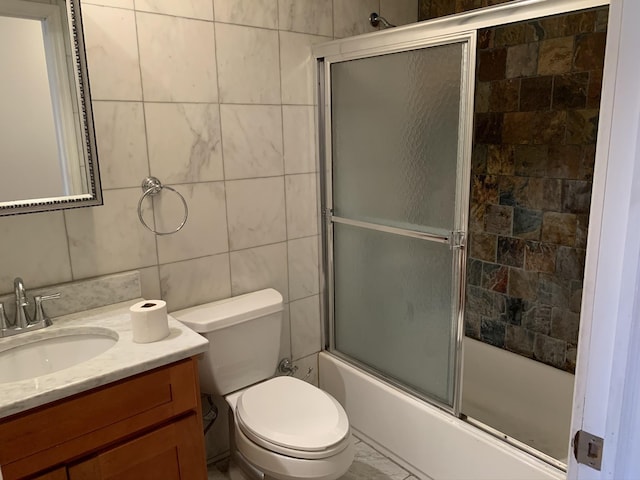 612 Palisade Ave, Jersey City, NJ 07307 - bathroom with toilet, tile walls, vanity, and shower / bath combination with glass door