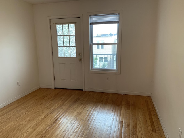 612 Palisade Ave, Jersey City, NJ 07307 - doorway to outside with plenty of natural light, light wood-type flooring, and baseboards