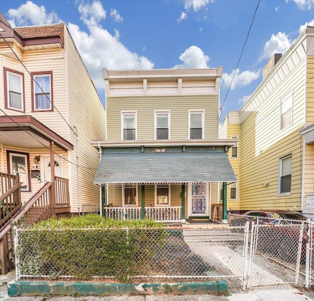 townhome / multi-family property with covered porch