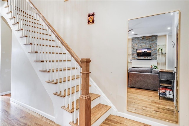 staircase with hardwood / wood-style flooring