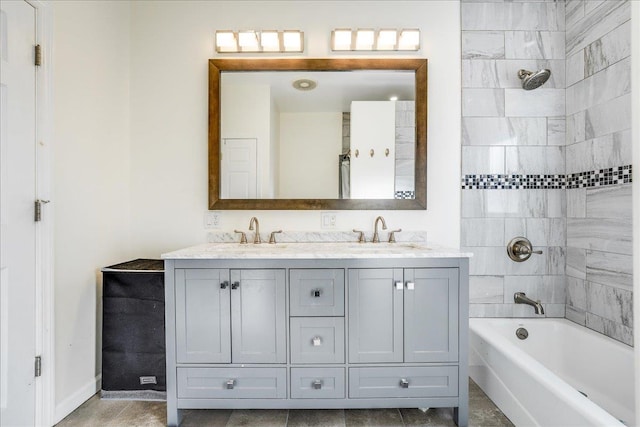 bathroom with tiled shower / bath and vanity