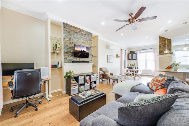 living room featuring a wall mounted air conditioner, ceiling fan, ornamental molding, and light hardwood / wood-style floors