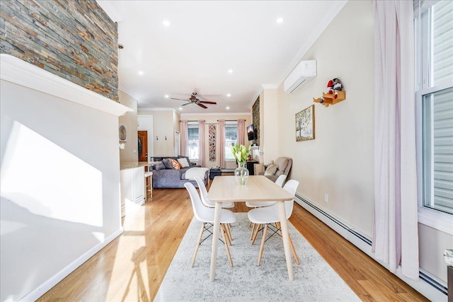 dining space with crown molding, light wood-type flooring, a wall mounted air conditioner, and ceiling fan