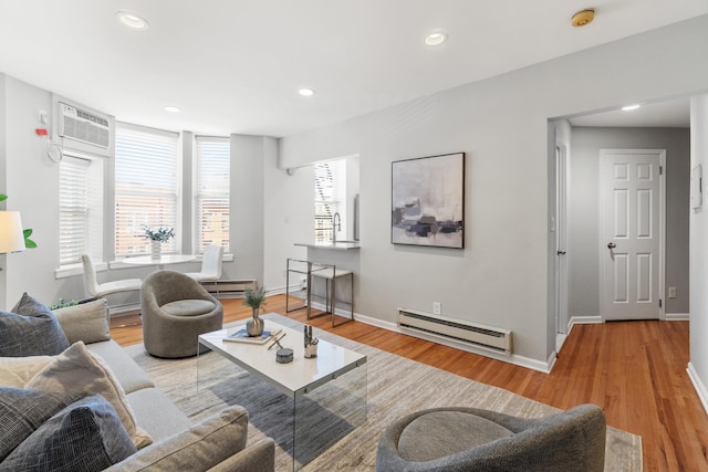 living room featuring a baseboard heating unit, recessed lighting, wood finished floors, and baseboards