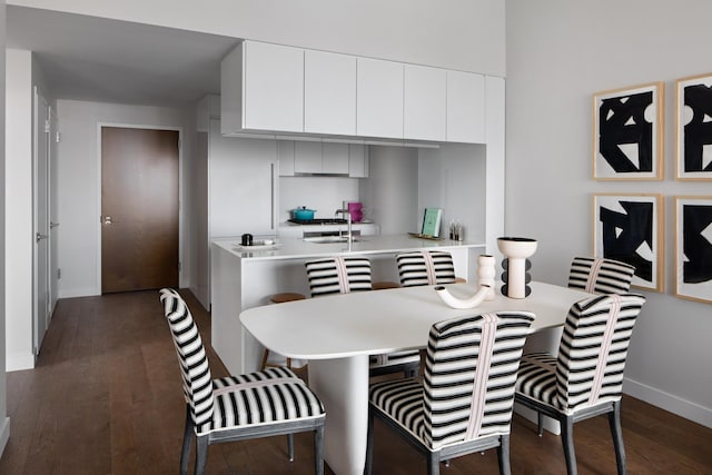 dining area with dark hardwood / wood-style flooring and sink