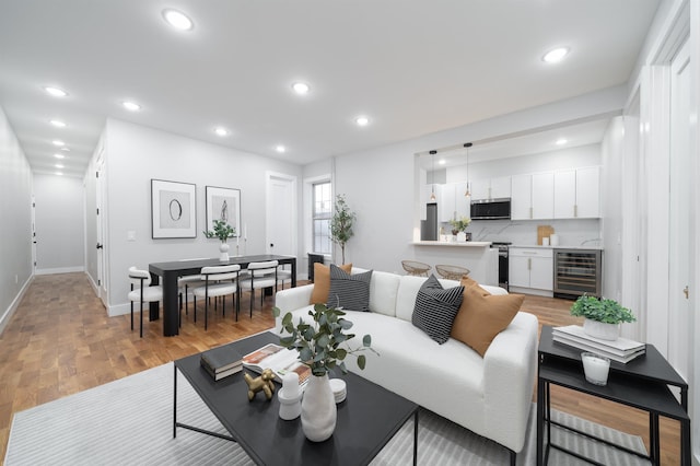 living room featuring beverage cooler and light wood-type flooring