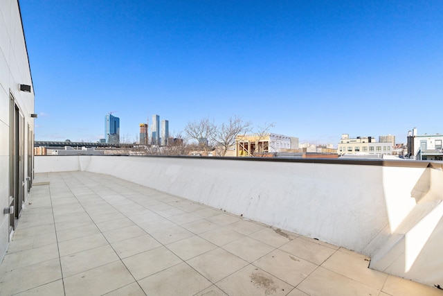 view of patio / terrace with a balcony and a city view