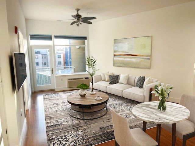 living room with wood-type flooring, a wall mounted AC, and ceiling fan