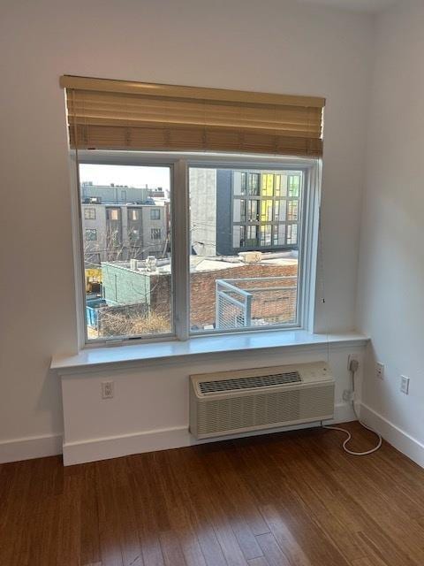 details with hardwood / wood-style flooring and an AC wall unit