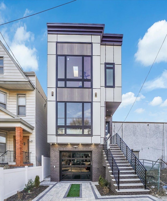177 Wilkinson Ave Unit 1, Jersey City, NJ 07305 - contemporary home with brick siding, stairs, and a garage