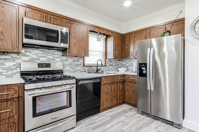 131 Iozia Ter, Elmwood Park, NJ 07407 - kitchen with a sink, light wood-style flooring, appliances with stainless steel finishes, light countertops, and ornamental molding