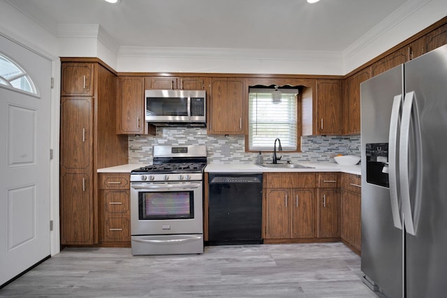 131 Iozia Ter, Elmwood Park, NJ 07407 - kitchen featuring ornamental molding, appliances with stainless steel finishes, a sink, and light countertops