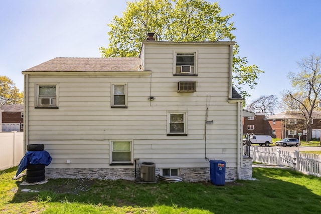 131 Iozia Ter, Elmwood Park, NJ 07407 - back of property with a yard, a chimney, central AC unit, and fence