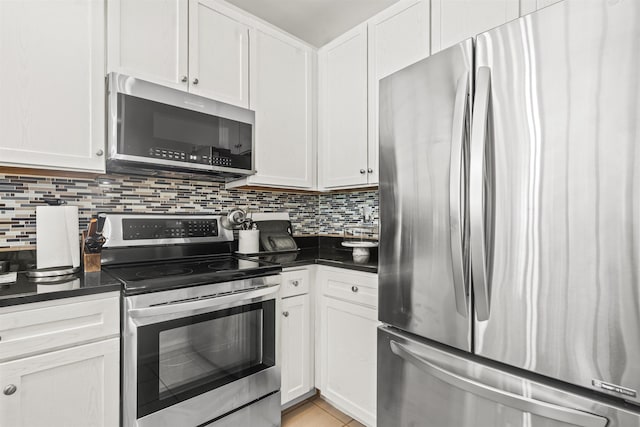 24 Ave At Port Imperial Unit 328, West New York, NJ 07093 - kitchen featuring appliances with stainless steel finishes, dark countertops, backsplash, and white cabinets