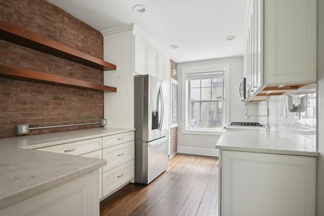 1000 Hudson St Unit 209, Hoboken, NJ 07030 - kitchen with stainless steel fridge, open shelves, tasteful backsplash, white cabinets, and light countertops