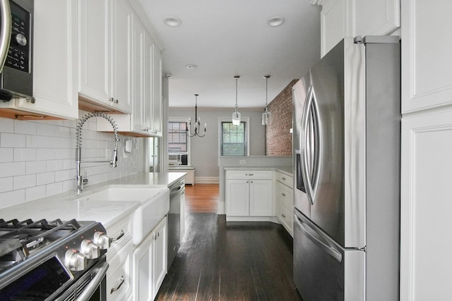 1000 Hudson St Unit 209, Hoboken, NJ 07030 - kitchen with appliances with stainless steel finishes, dark wood-style flooring, decorative backsplash, white cabinets, and recessed lighting
