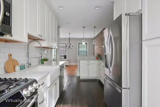 1000 Hudson St Unit 209, Hoboken, NJ 07030 - kitchen with appliances with stainless steel finishes, dark wood-style flooring, white cabinetry, light countertops, and decorative backsplash