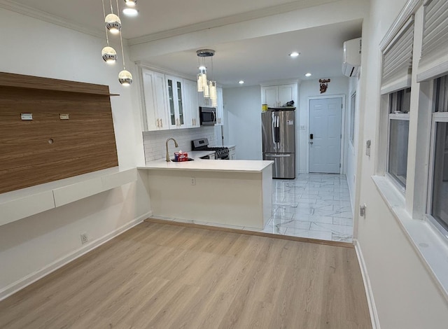 67 Winfield Ave, Jersey City, NJ 07305 - kitchen featuring stainless steel appliances, a peninsula, a wall mounted air conditioner, white cabinetry, and glass insert cabinets