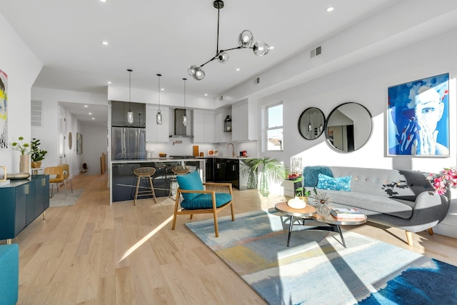 living room with sink and light hardwood / wood-style flooring