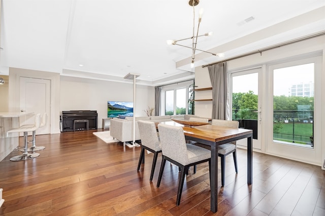 150 Henley Pl Unit 202, Weehawken, NJ 07086 - dining area featuring hardwood / wood-style flooring, a chandelier, and a raised ceiling