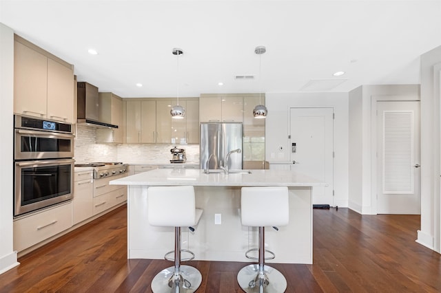 150 Henley Pl Unit 202, Weehawken, NJ 07086 - kitchen featuring stainless steel appliances, wall chimney range hood, backsplash, dark wood-type flooring, and a kitchen bar