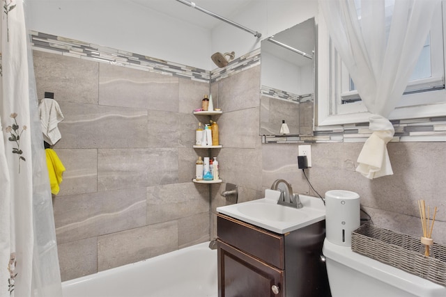 full bath featuring vanity, toilet, and washtub / shower combination
