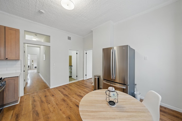 3809 Kennedy Blvd, Union City, NJ 07087 - dining space featuring crown molding, light wood-type flooring, and baseboards