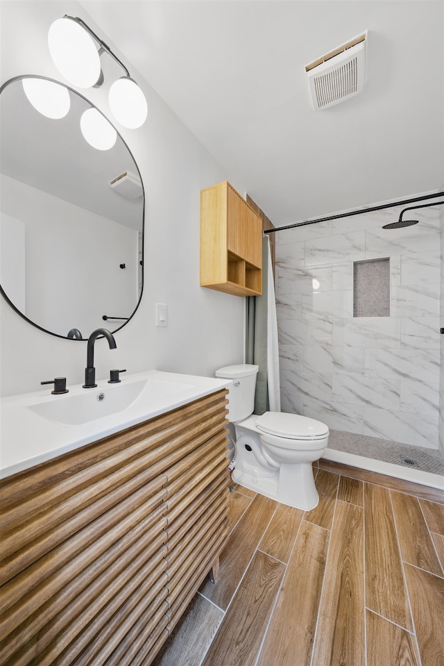 3809 Kennedy Blvd, Union City, NJ 07087 - bathroom with toilet, vanity, a tile shower, and wood tiled floors