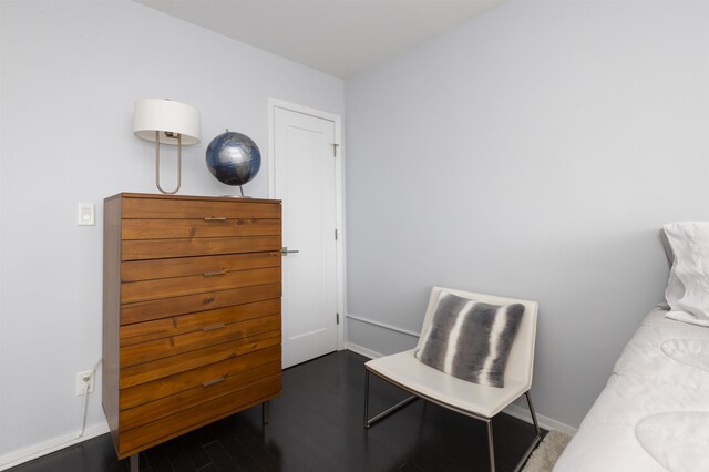 living area with wood finished floors and baseboards