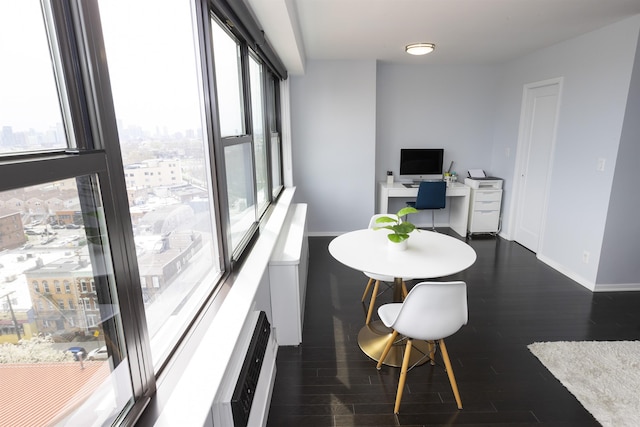 dining space with plenty of natural light, dark wood finished floors, and baseboards