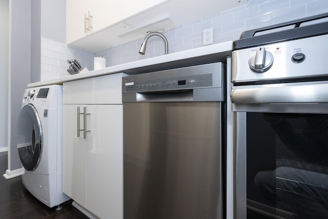 clothes washing area featuring washer / clothes dryer and dark wood-type flooring