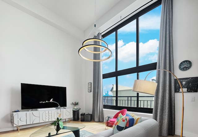 518 Gregory Ave Unit A213, Weehawken, NJ 07086 - living room with a chandelier, wood finished floors, plenty of natural light, and a towering ceiling
