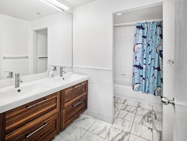 518 Gregory Ave Unit A213, Weehawken, NJ 07086 - bathroom featuring marble finish flooring, double vanity, shower / tub combo, a wainscoted wall, and tile walls