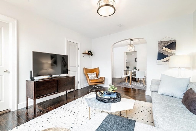 living room with dark hardwood / wood-style flooring