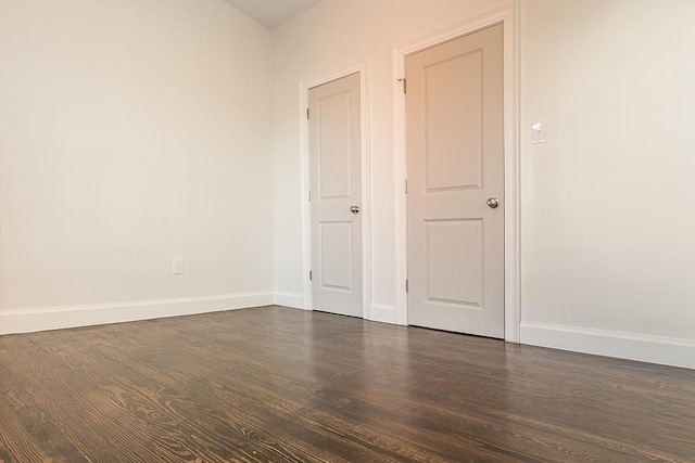 unfurnished room featuring dark hardwood / wood-style flooring