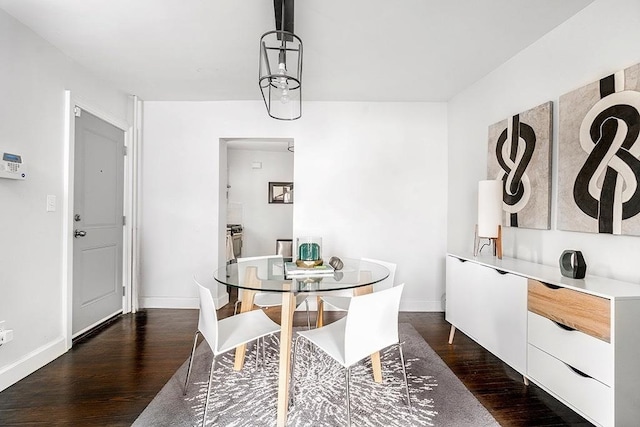 dining space with dark hardwood / wood-style floors