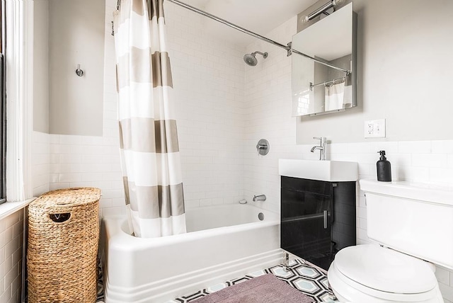 full bathroom with vanity, toilet, tile walls, and shower / bath combo with shower curtain