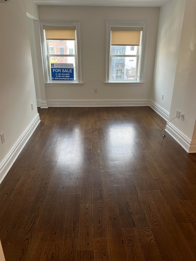 spare room with dark hardwood / wood-style floors