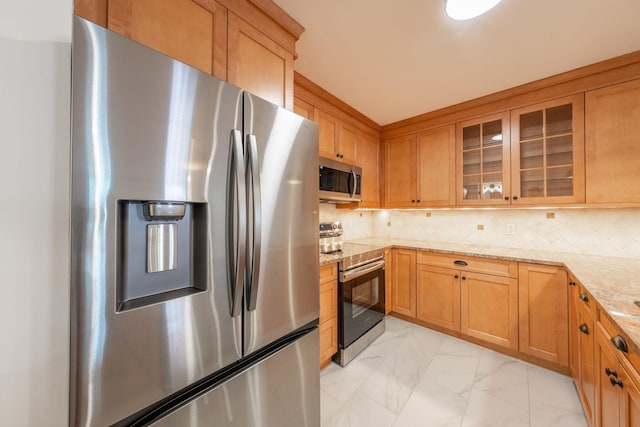 224 Park Ave Unit 1, Hoboken, NJ 07030 - kitchen featuring appliances with stainless steel finishes, light marble finish floors, glass insert cabinets, light stone countertops, and decorative backsplash