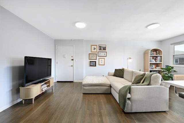 living room featuring baseboards and dark wood finished floors