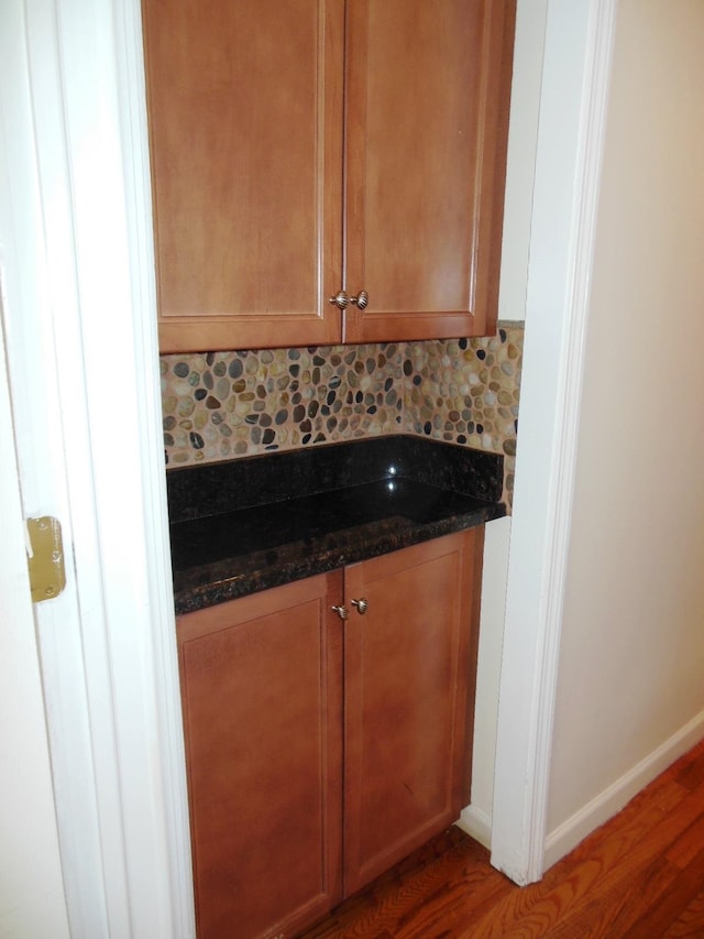 interior space with hardwood / wood-style floors, decorative backsplash, and vanity