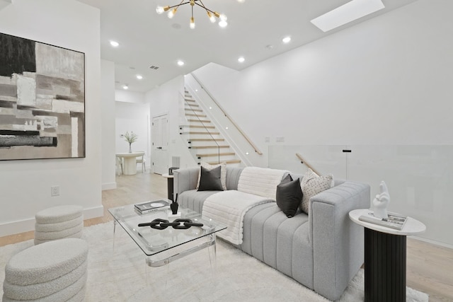 living room featuring light hardwood / wood-style flooring and a chandelier